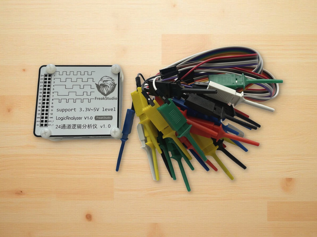24-channel logic analyzer in a clear case, with a bundle of coloured test hooks