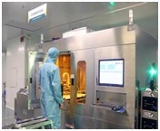 Operator in a clean suit at an LDI exposure machine
