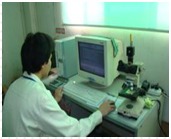 Technician at a microsection analysis station