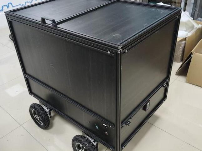 Black four-wheel cargo robot for indoor delivery