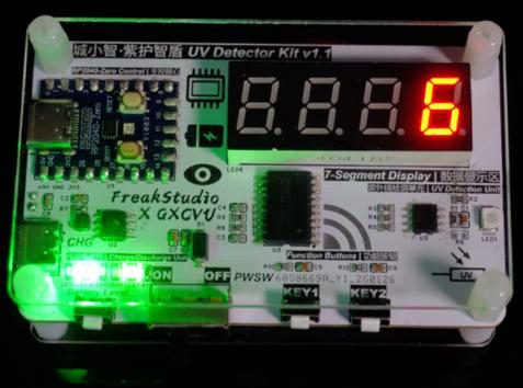 Kit board in a clear acrylic case with a red 7-segment display reading 6 and green status LEDs