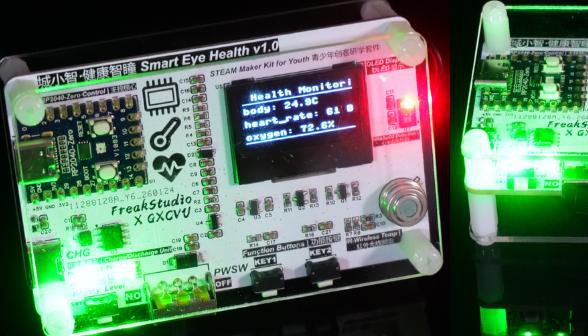 Kit board in an acrylic case with an OLED showing body temperature, heart rate and oxygen readings