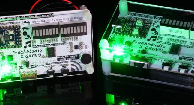 Two kit boards with 16-LED bar displays and a microphone, green LEDs lit