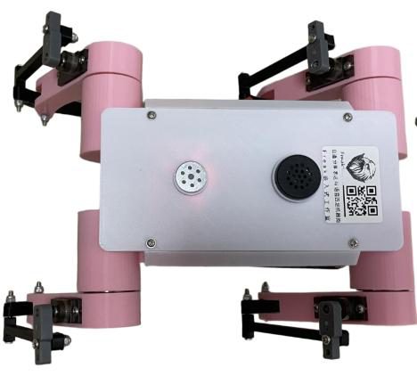 Top view of the pink quadruped's white lid with the microphone, speaker and a sticker with a QR code and logo