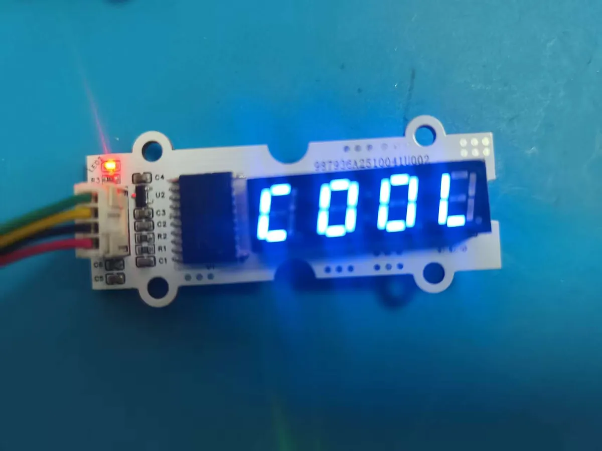 Four-digit seven-segment display module showing the word COOL in blue