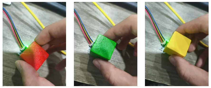 Three photos of a hand holding red, green and yellow cubes against a sensor, each at a slightly different angle and distance