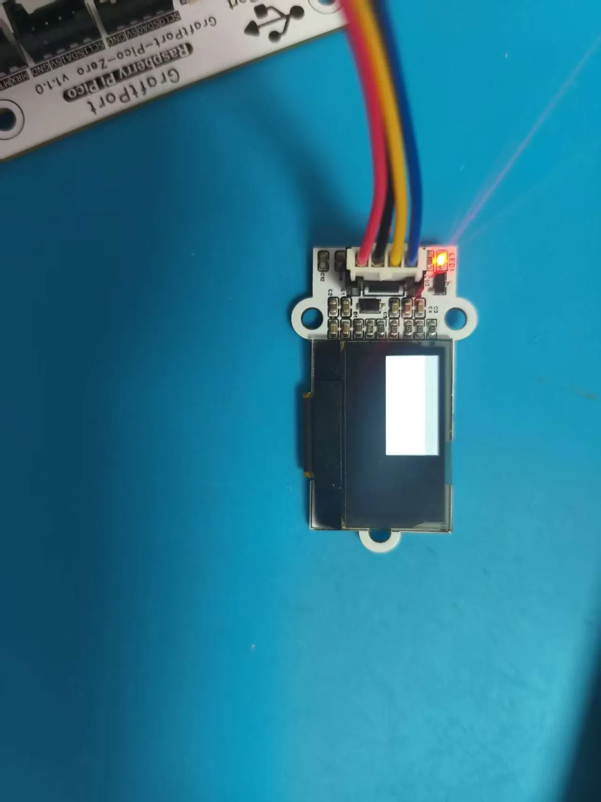 OLED module showing a filled white rectangle in the upper left of the panel