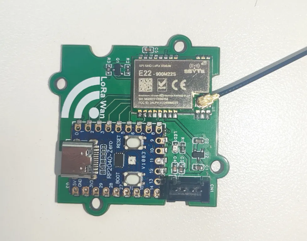 E22-900M22S radio module with antenna cable on a green carrier board beside an RP2040-Zero