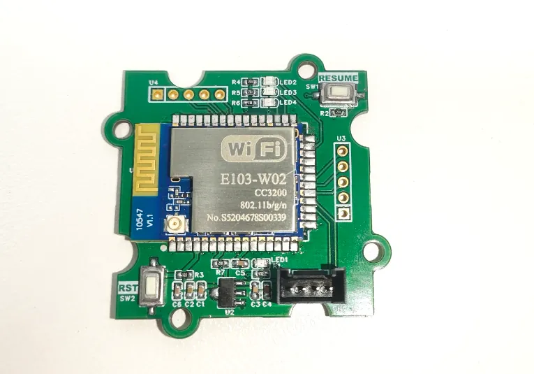 Green module board with the E103-W02 Wi-Fi module, its PCB antenna at the left edge, status LEDs and a four-pin connector