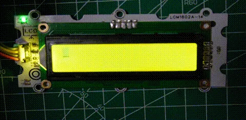 Two-line character LCD showing a blinking cursor, then Hello World, then cursor-only states, with the backlight on throughout